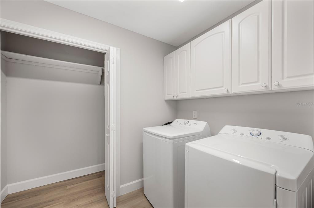 241 Greenfield Road Winter Haven, FL 33884 - Photo 21 of 43 a view of storage and utility room with washer and dryer