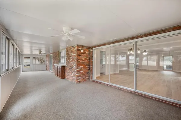 a view of empty room with cabinet and floor to ceiling window