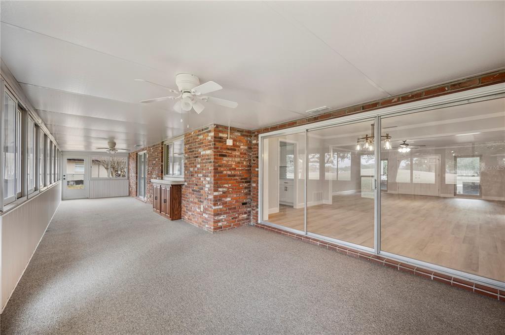 241 Greenfield Road Winter Haven, FL 33884 - Photo 23 of 43 a view of empty room with cabinet and floor to ceiling window