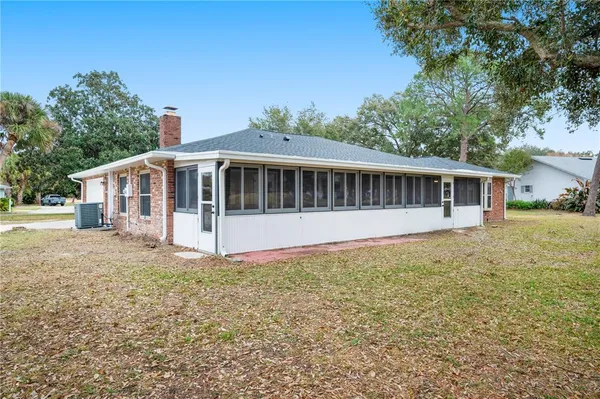 a view of a house with backyard and sitting area