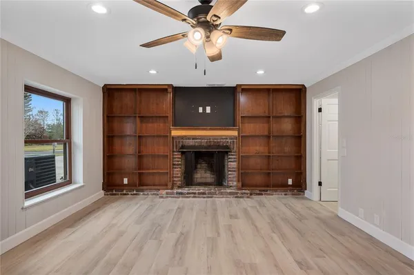 a view of a livingroom with a fireplace and window
