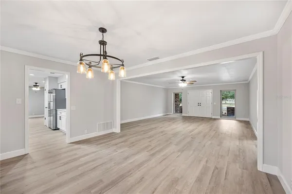 a view of a room with wooden floor and windows