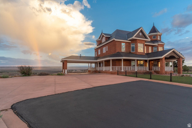 5615 East Eight Mile Gap Road Kanab, UT 84741 - Photo 66 of 81 View of front of property featuring a porch, brick siding, and driveway