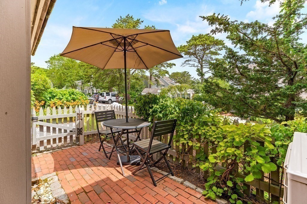 3 Folgers Way, Unit 3 Mashpee, MA 02649 - Photo 8 of 21 a view of a chair and table in the patio with a fire pit