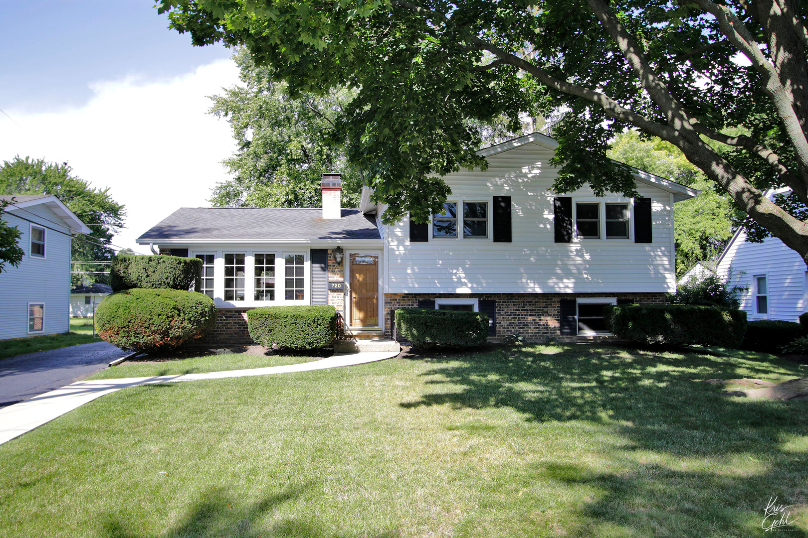 a aerial view of a house with a yard table and chairs