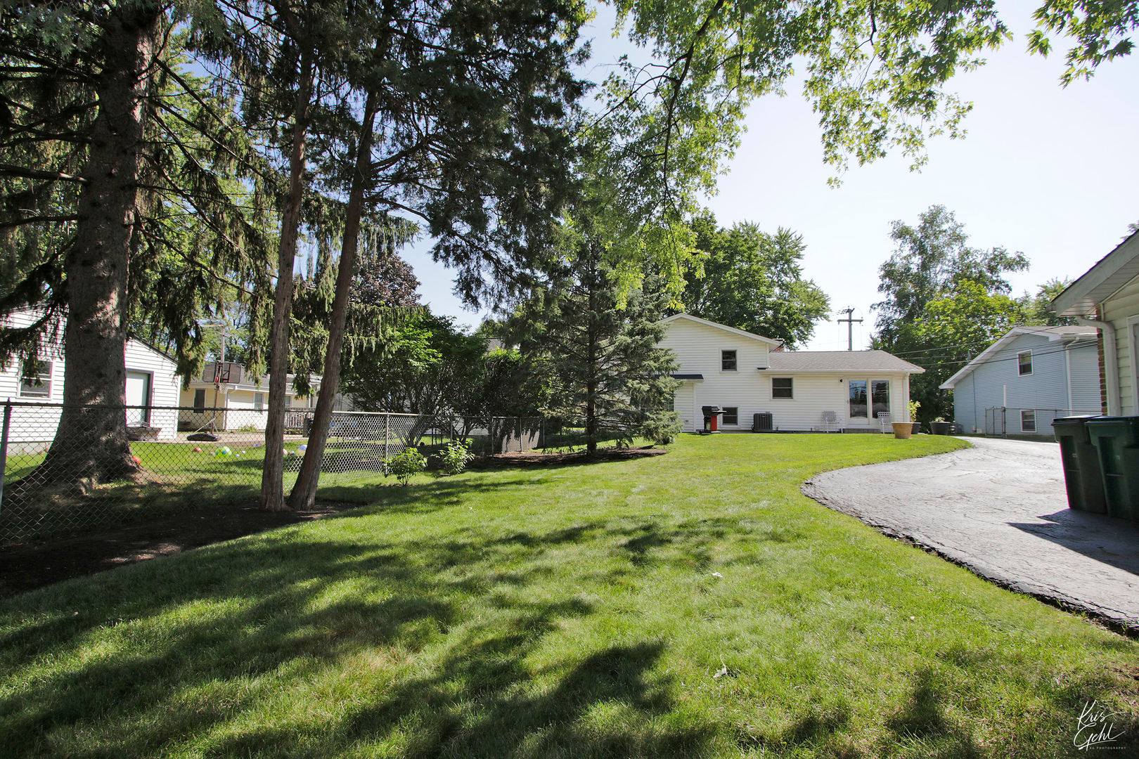 720 Stuart Street Grayslake, IL 60030 - Photo 17 of 19 a view of a house with a big yard and large trees