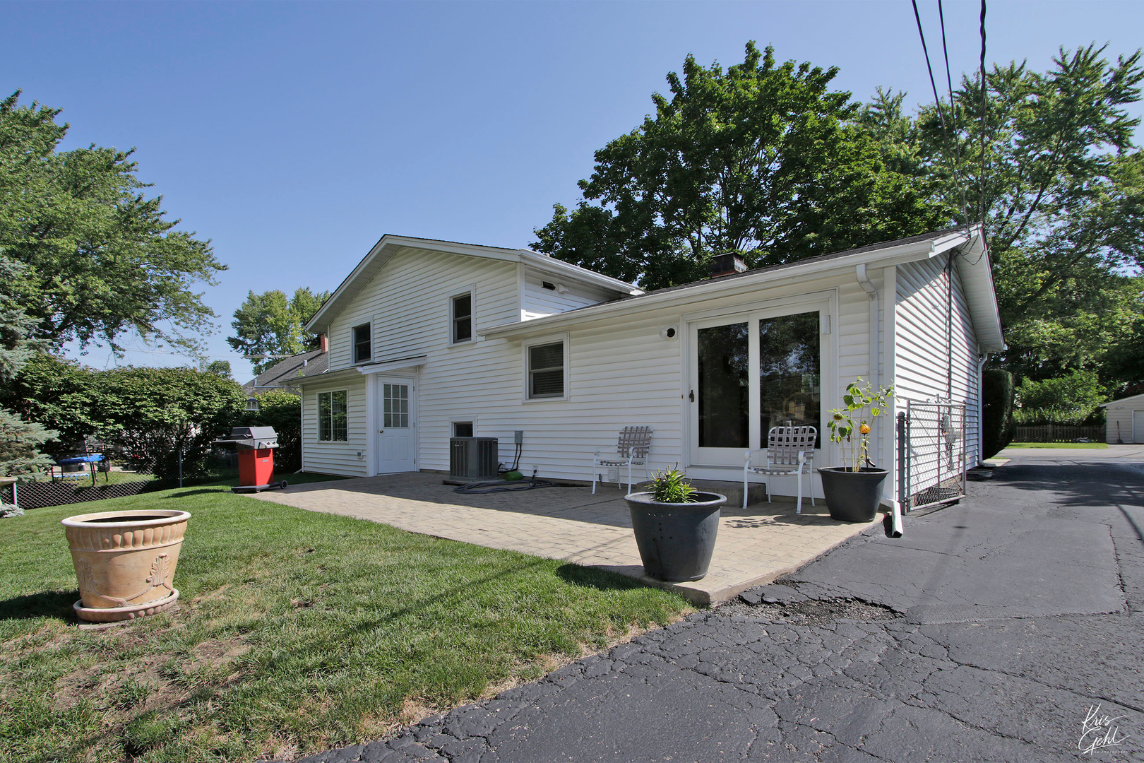 720 Stuart Street Grayslake, IL 60030 - Photo 18 of 19 a view of a patio with table and chairs and potted plants