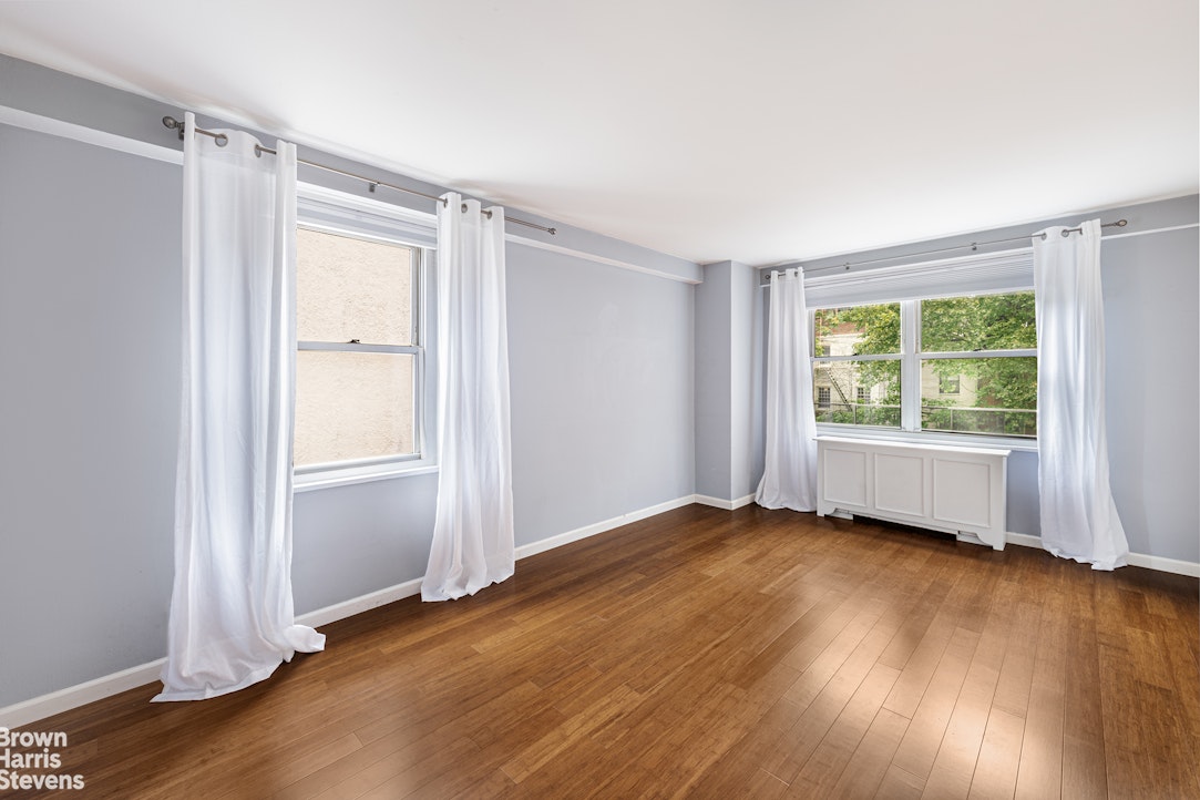 251 East 32nd Street, Unit 4J Manhattan, NY 10016 - Photo 10 of 15 an empty room with wooden floor and windows