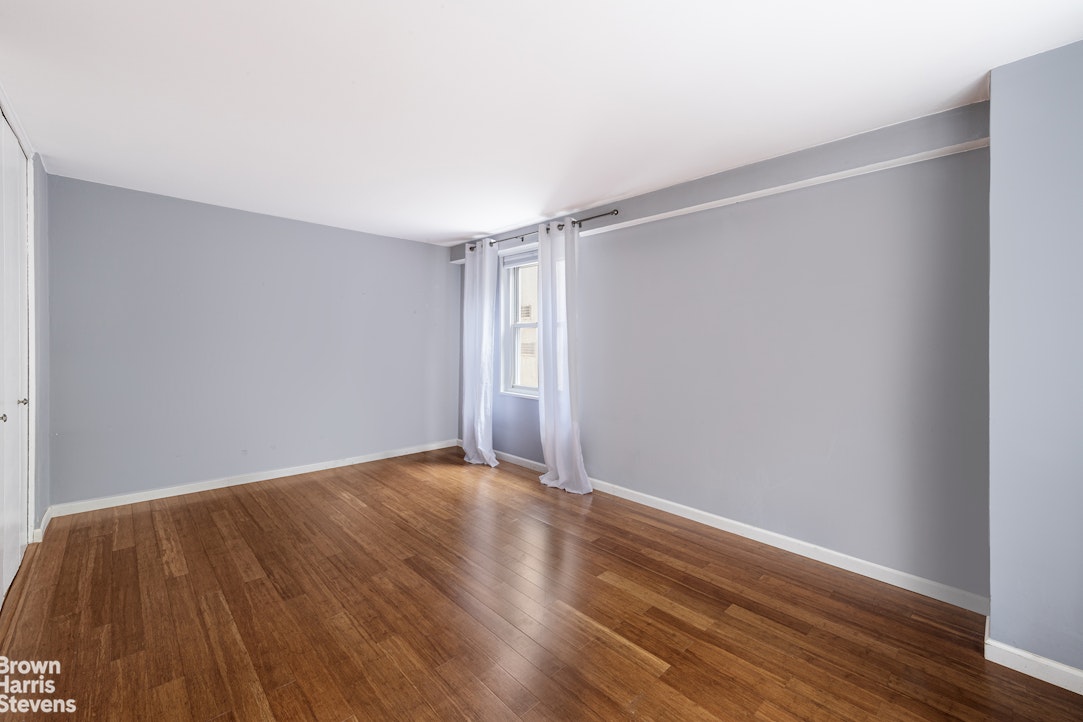 251 East 32nd Street, Unit 4J Manhattan, NY 10016 - Photo 11 of 15 a view of an empty room with wooden floor