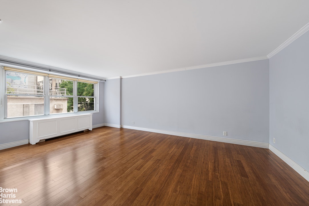251 East 32nd Street, Unit 4J Manhattan, NY 10016 - Photo 12 of 15 an empty room with wooden floor and windows