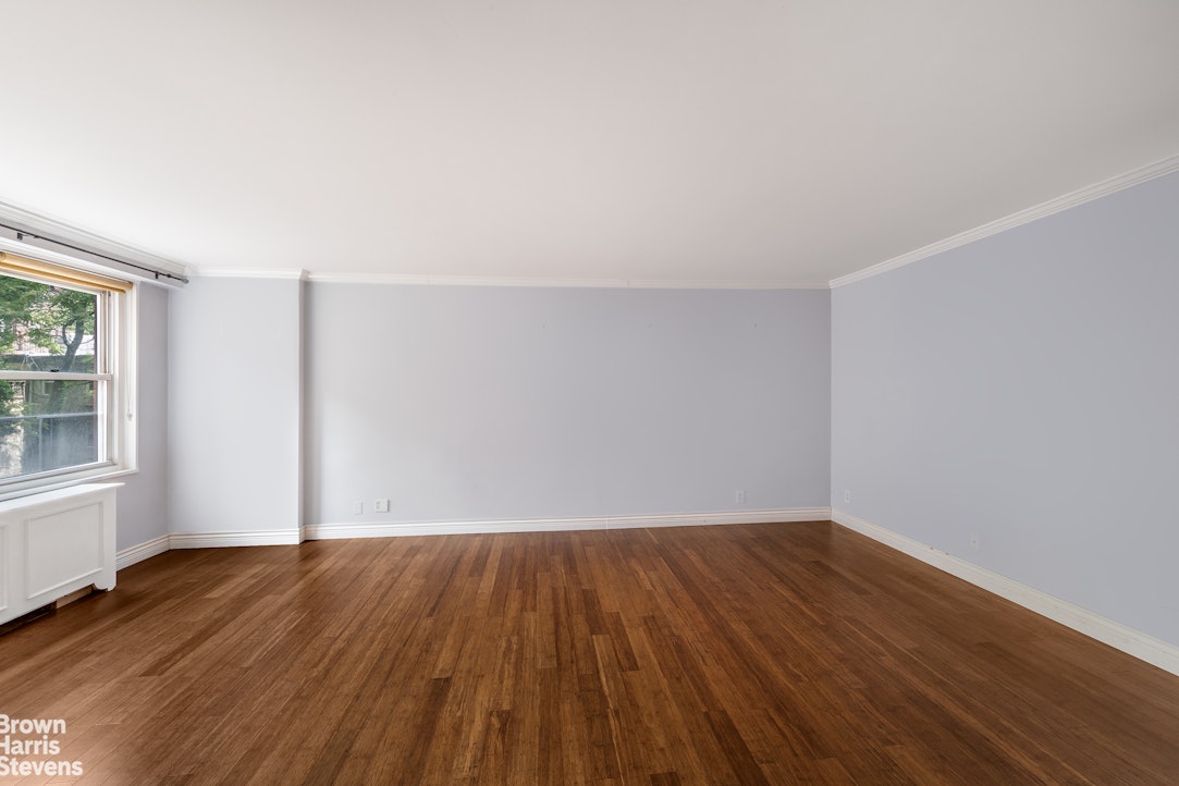 251 East 32nd Street, Unit 4J Manhattan, NY 10016 - Photo 14 of 15 an empty room with wooden floor and windows