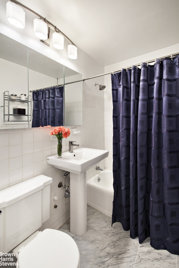 251 East 32nd Street, Unit 4J Manhattan, NY 10016 - Photo 5 of 15 a bathroom with a sink toilet and shower