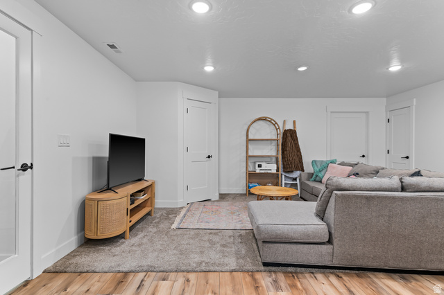 1426 South 1450th Street West Mapleton, UT 84664 - Photo 31 of 50 Open living area featuring recessed lighting, a combination of wood-finish flooring and carpeting, and multiple white paneled doors with black hardware