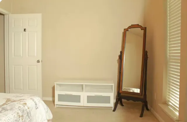 a view of bedroom with a bed and wooden floor