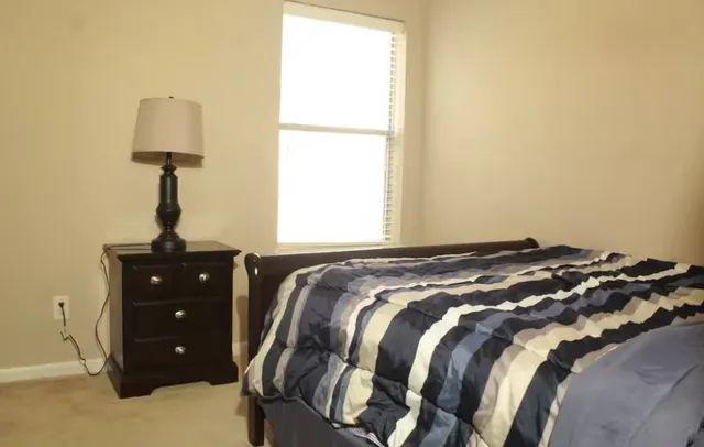 a bedroom with a bed and a window