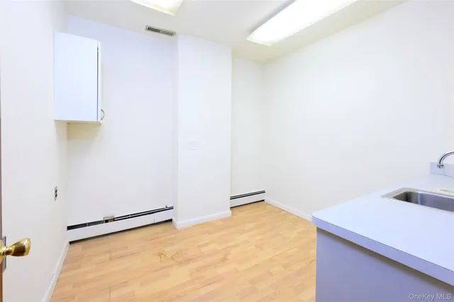 a bathroom with a sink toilet and mirror