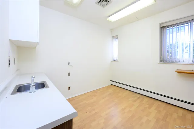 a view of room with window and wooden floor