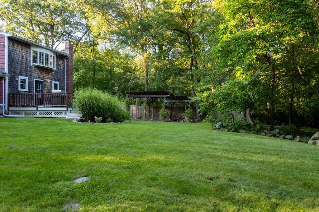 2046 Bay Road Stoughton, MA 02072 - Photo 24 of 25 a view of a brick house with a big yard plants and large trees