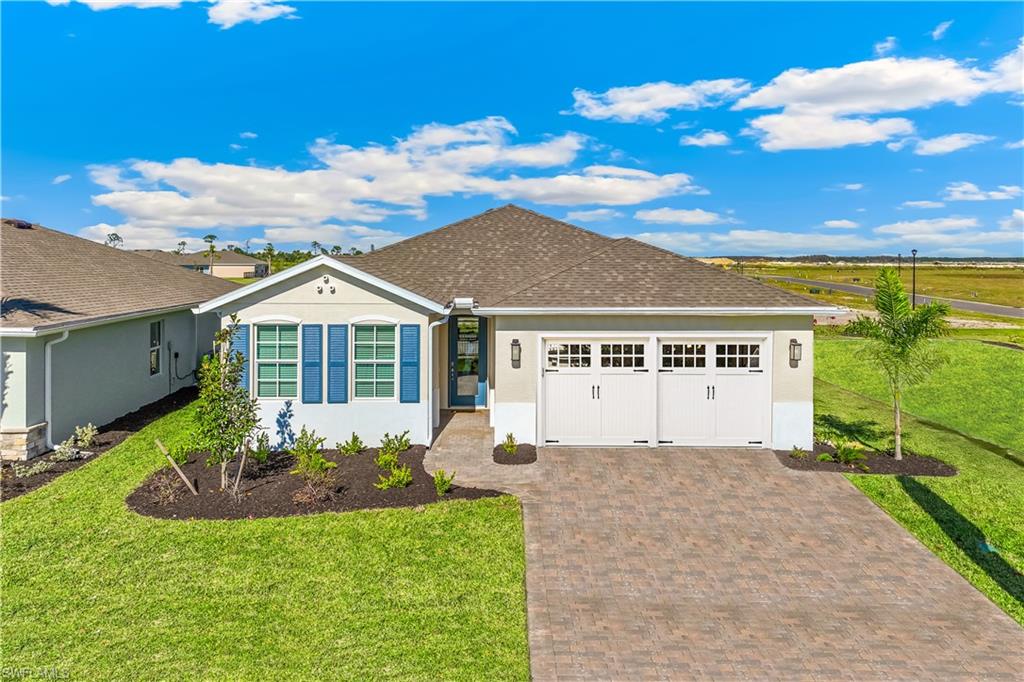 17899 Shade Tree Loop Punta Gorda, FL 33982 - Photo 1 of 47 a front view of a house with a yard and garage
