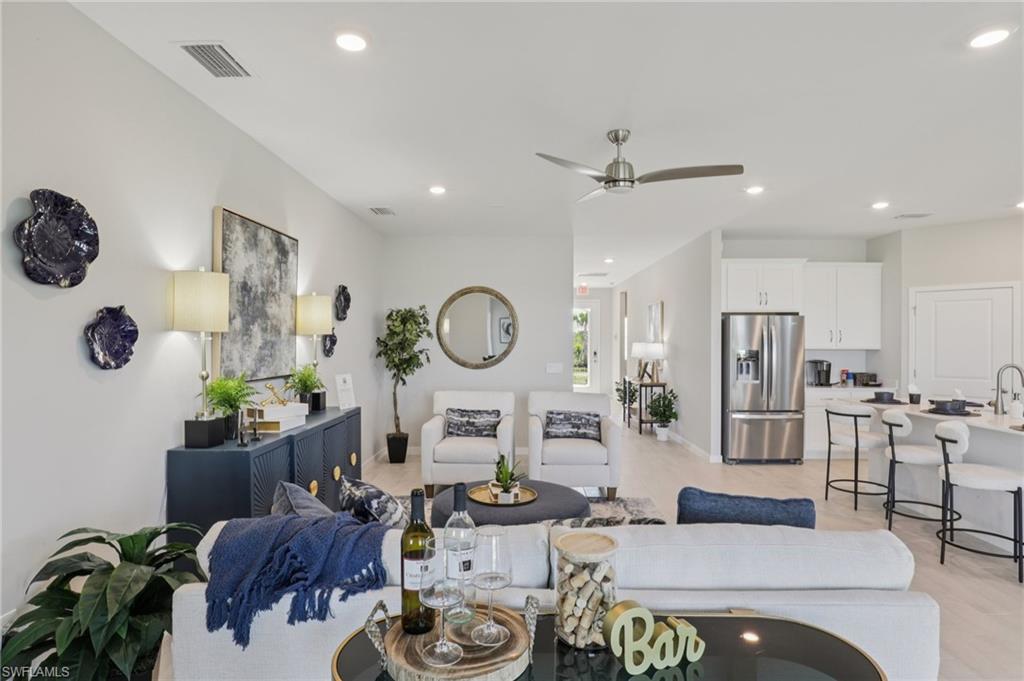 17899 Shade Tree Loop Punta Gorda, FL 33982 - Photo 19 of 47 a living room with furniture a chandelier and a window