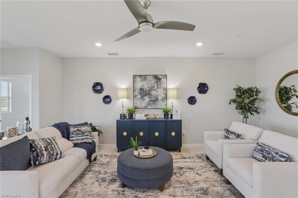 17899 Shade Tree Loop Punta Gorda, FL 33982 - Photo 2 of 47 a living room with furniture and a large window