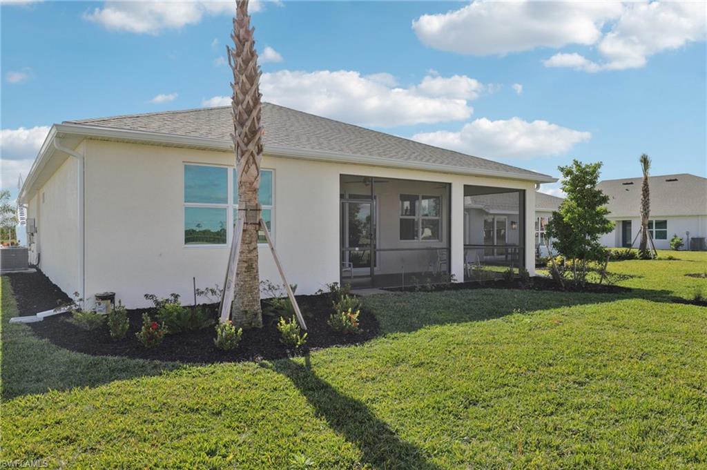 17899 Shade Tree Loop Punta Gorda, FL 33982 - Photo 24 of 47 a front view of a house with garden