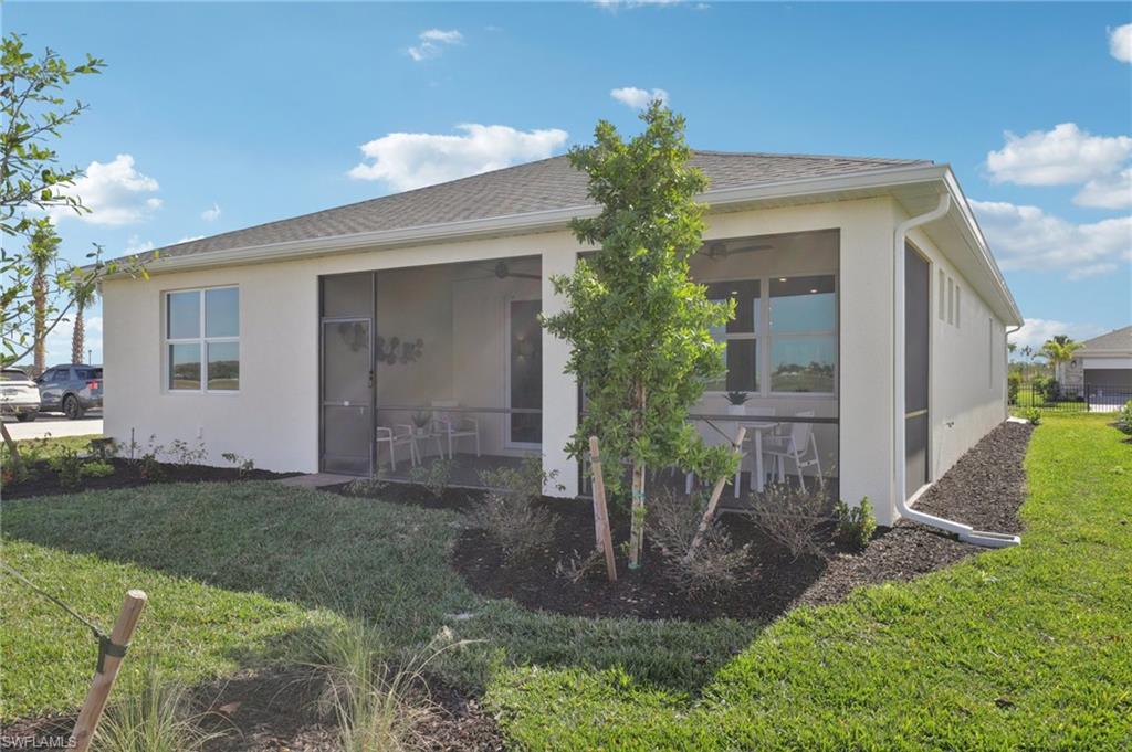 17899 Shade Tree Loop Punta Gorda, FL 33982 - Photo 25 of 47 a front view of a house with a yard