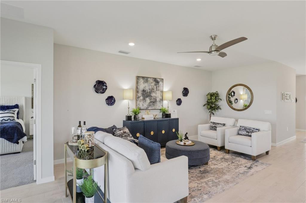 17899 Shade Tree Loop Punta Gorda, FL 33982 - Photo 4 of 47 a living room with furniture and a clock