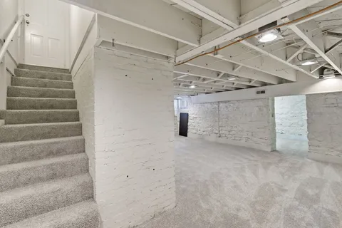 a view of an empty room with stairs