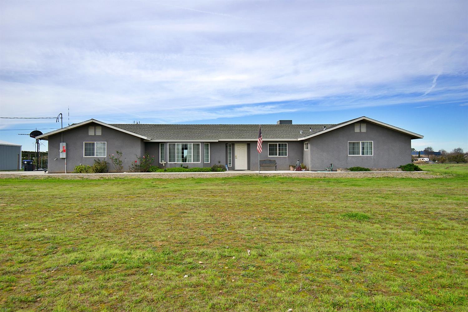 a house view with swimming pool in front of it