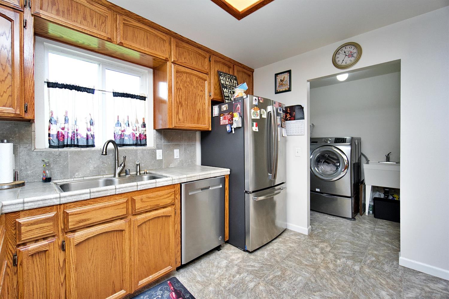 16254 Road 37 Madera, CA 93636 - Photo 12 of 36 a kitchen with stainless steel appliances granite countertop a refrigerator and a sink