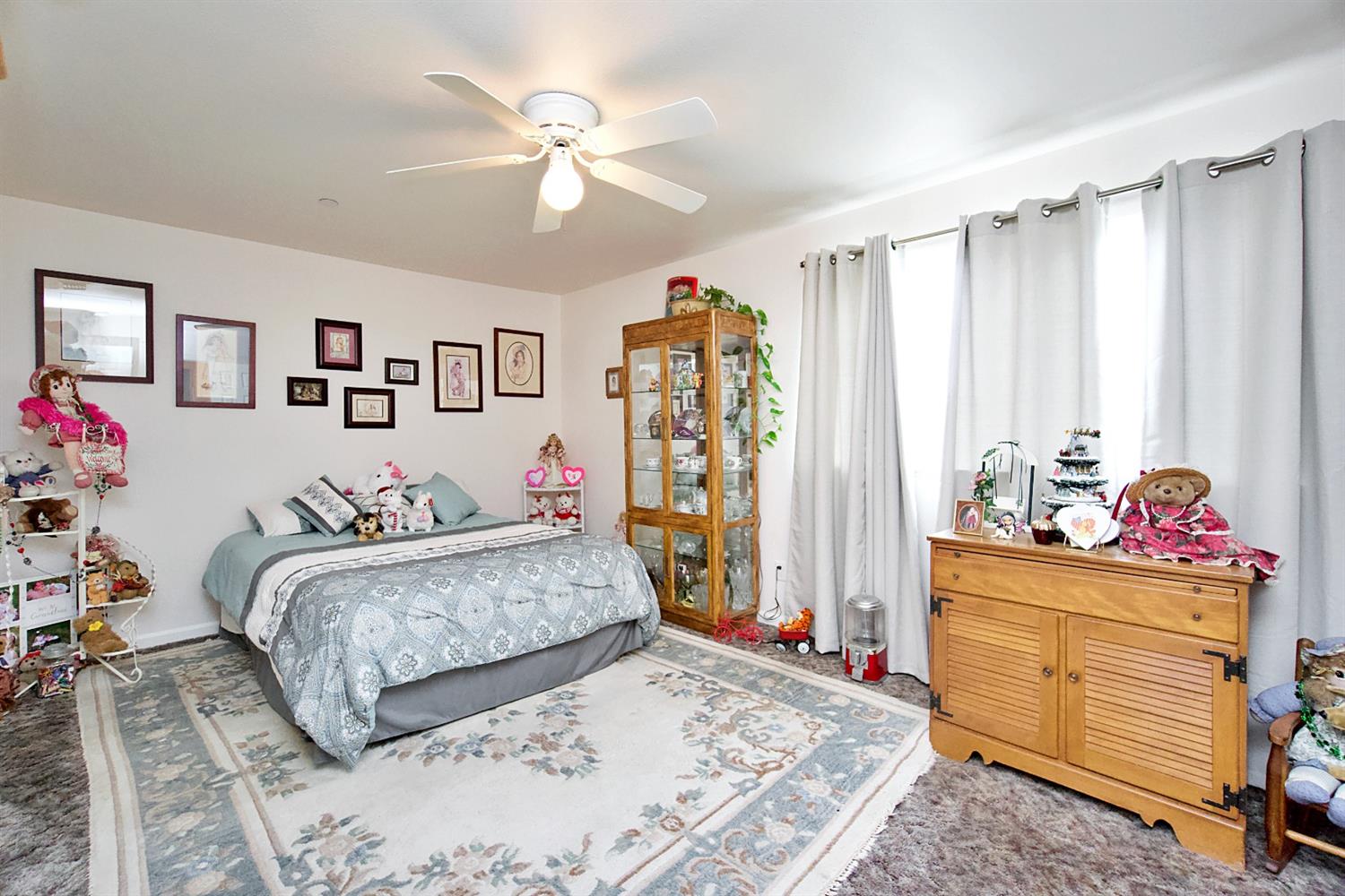 16254 Road 37 Madera, CA 93636 - Photo 17 of 36 a bedroom with a bed and a chandelier