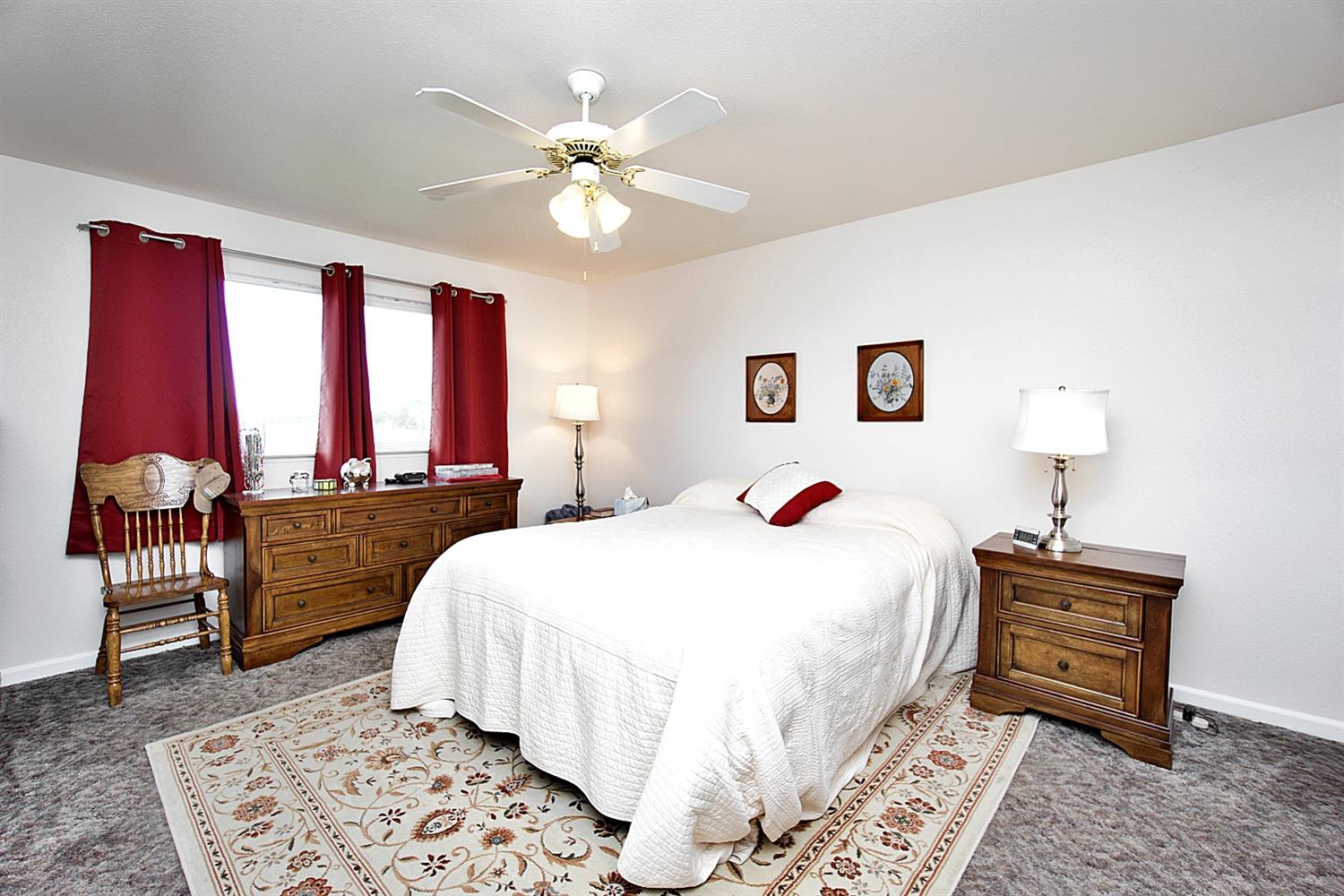 16254 Road 37 Madera, CA 93636 - Photo 19 of 36 a bedroom with a bed and a chandelier