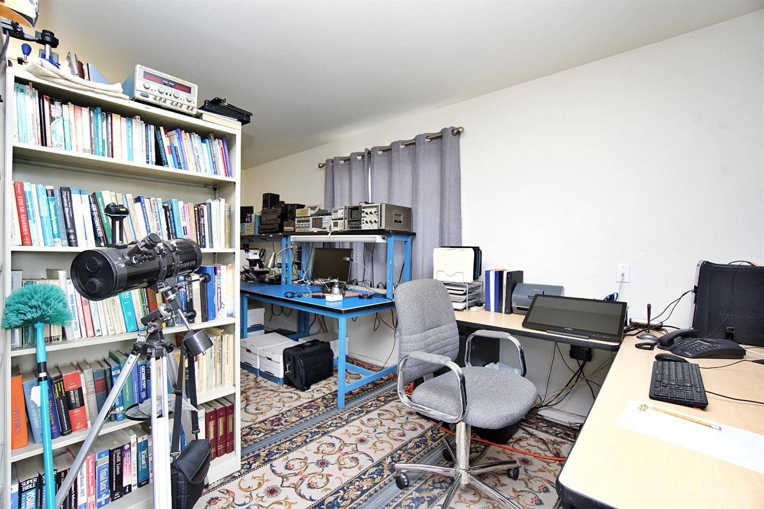 16254 Road 37 Madera, CA 93636 - Photo 23 of 36 a living room with furniture a rug and a book shelf