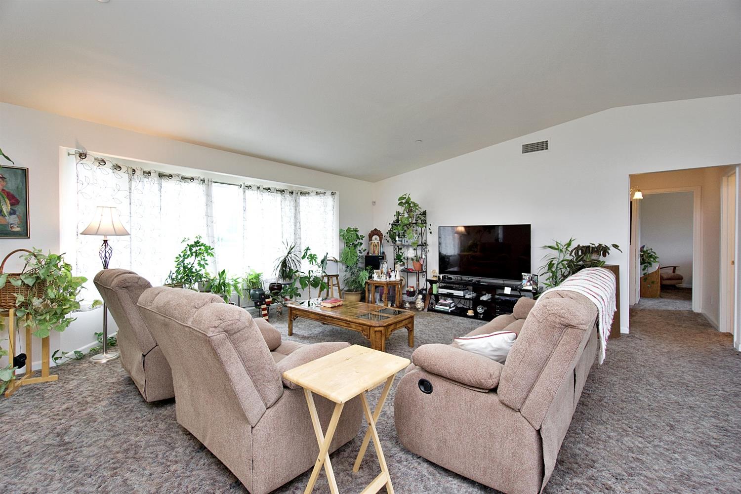 16254 Road 37 Madera, CA 93636 - Photo 6 of 36 a living room with furniture a flat screen tv and a large window