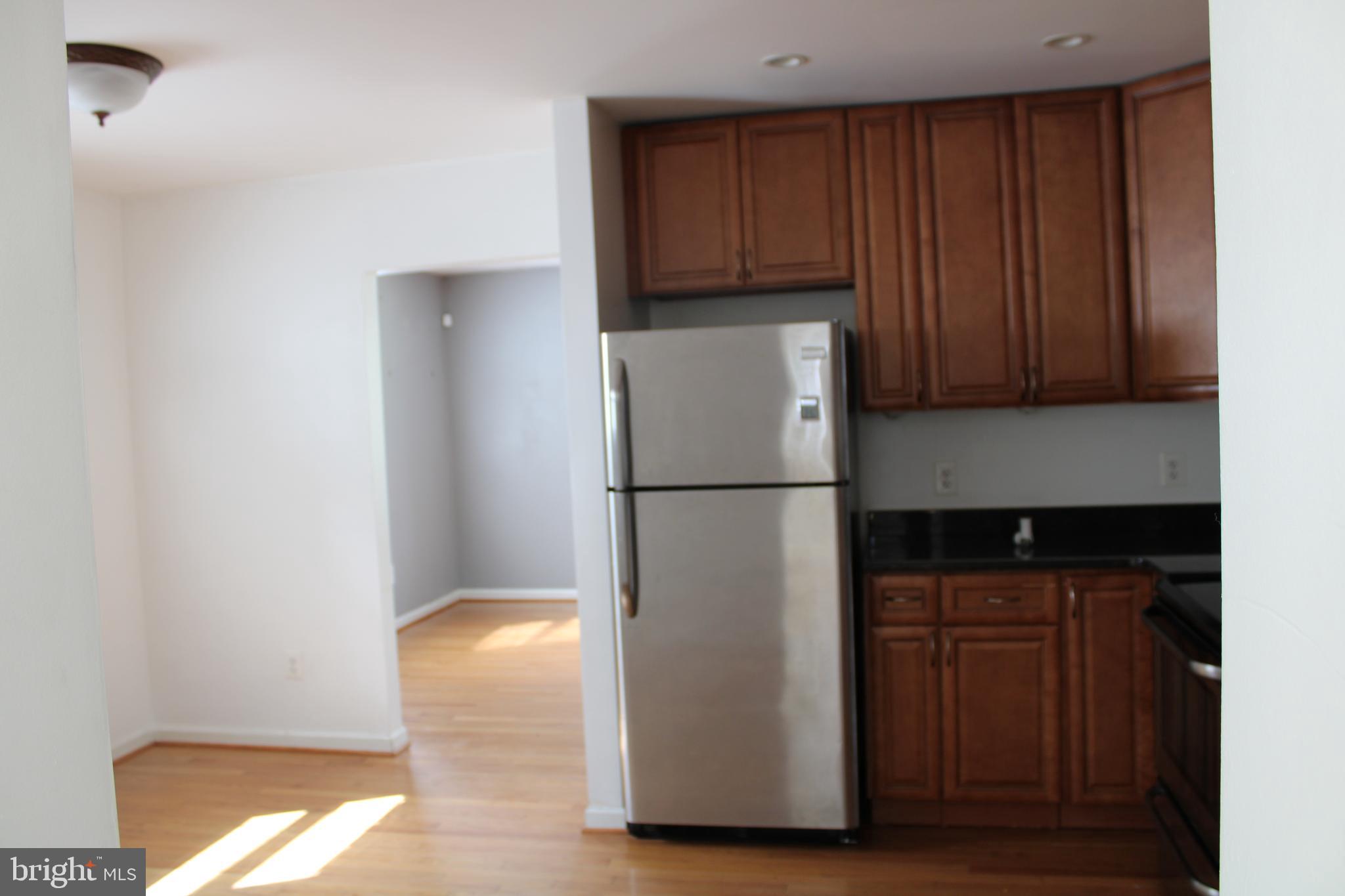 19115 Wayne Drive Triangle, VA 22172 - Photo 14 of 47 a kitchen with a refrigerator and a cabinets