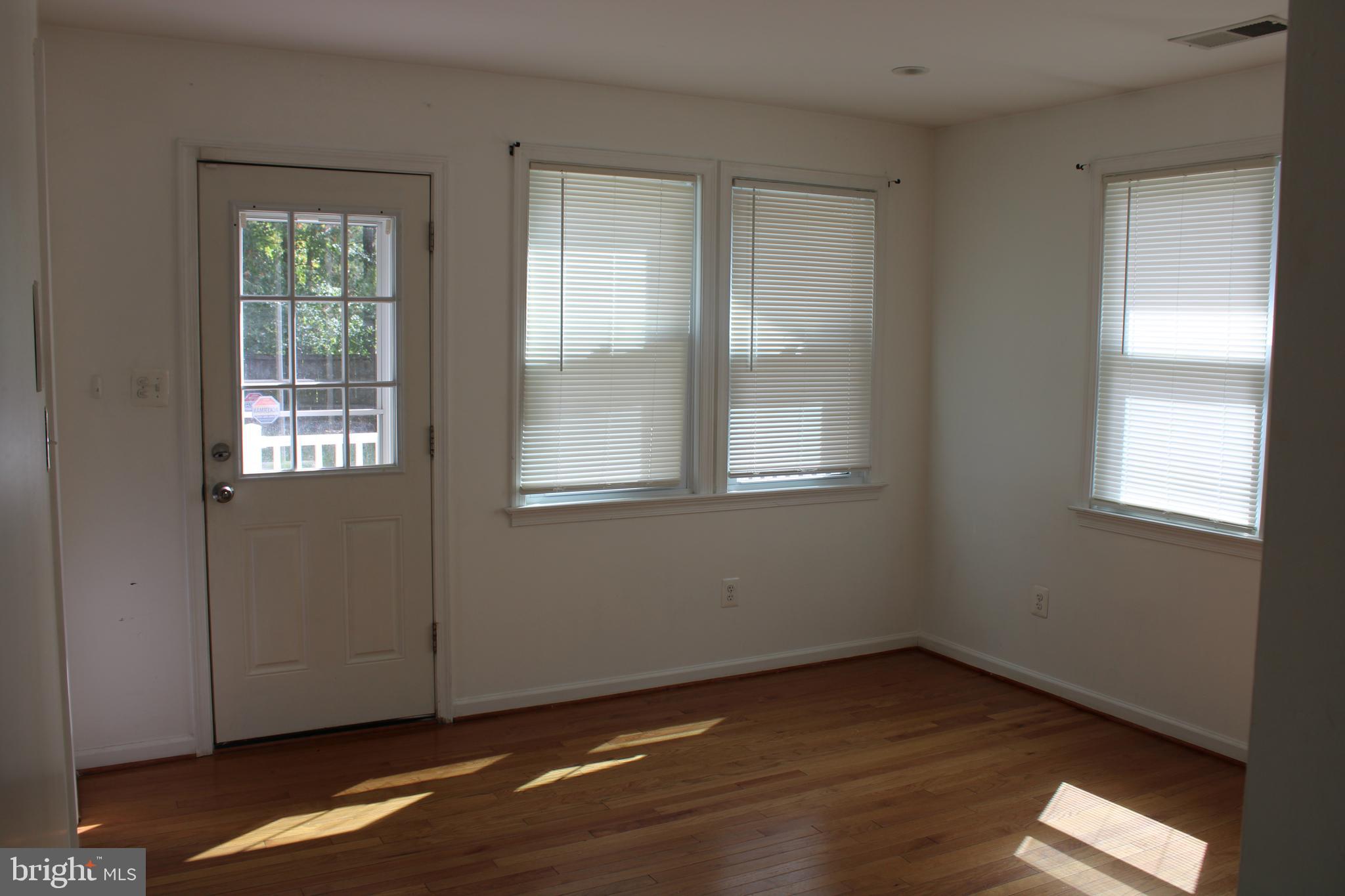 19115 Wayne Drive Triangle, VA 22172 - Photo 16 of 47 a view of an empty room with wooden floor and a window