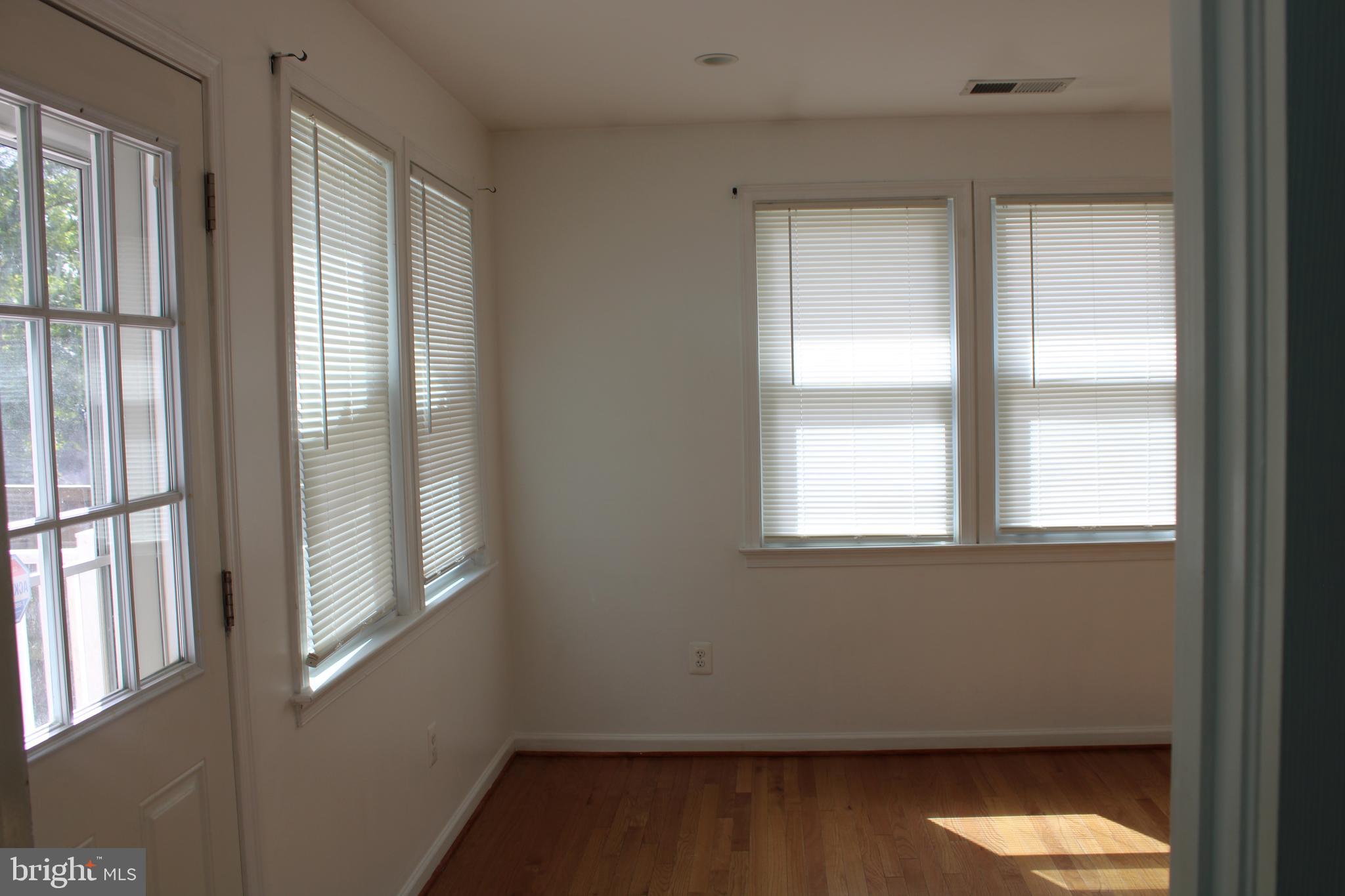 19115 Wayne Drive Triangle, VA 22172 - Photo 17 of 47 a view of an empty room with wooden floor and a window