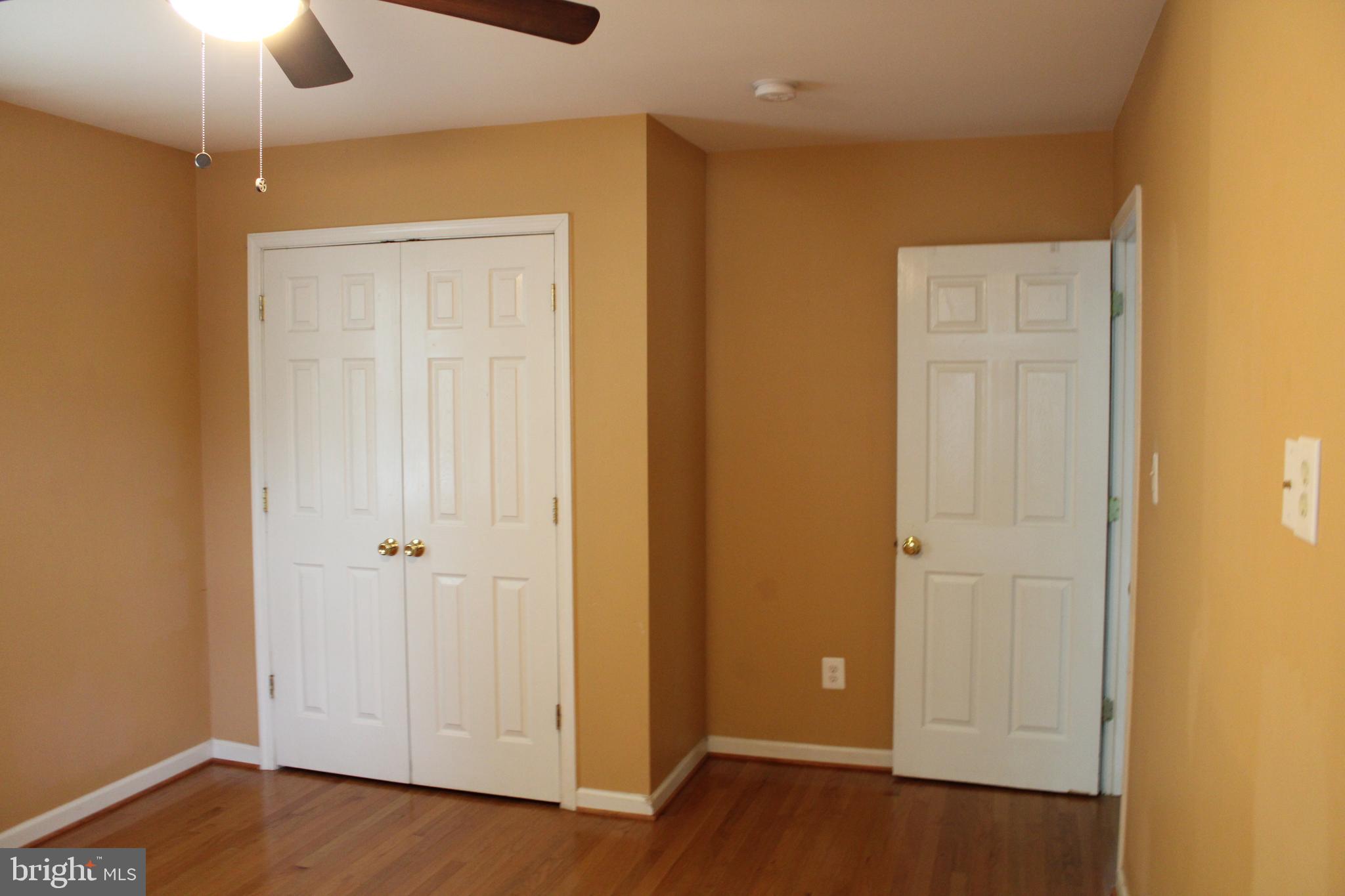 19115 Wayne Drive Triangle, VA 22172 - Photo 27 of 47 an empty room with wooden floor closet and windows