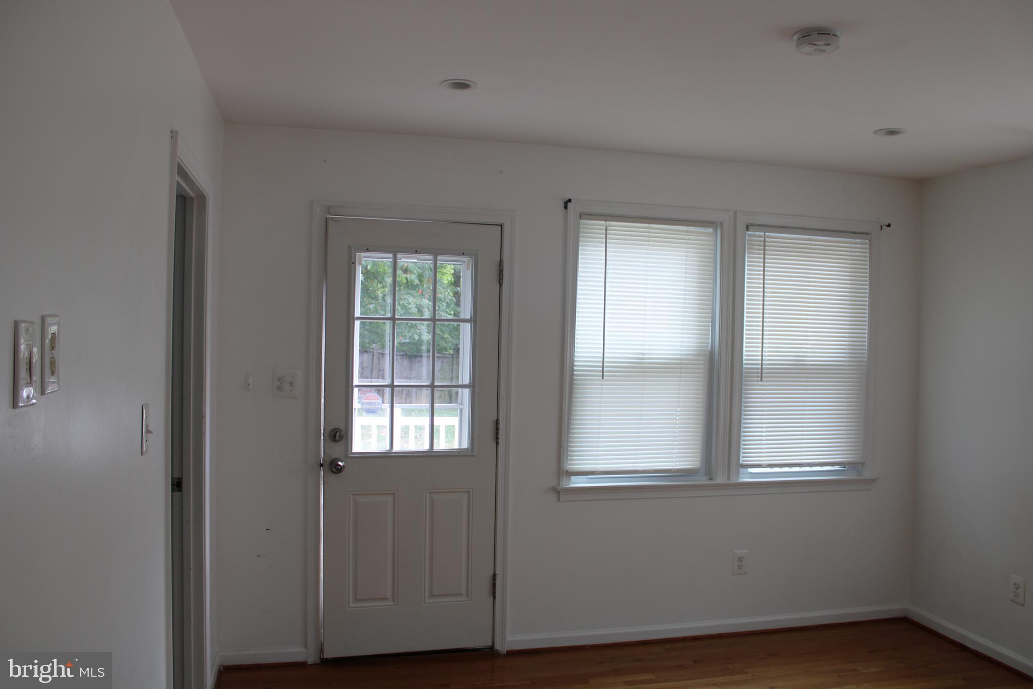 19115 Wayne Drive Triangle, VA 22172 - Photo 36 of 47 a view of an empty room with wooden floor and a window