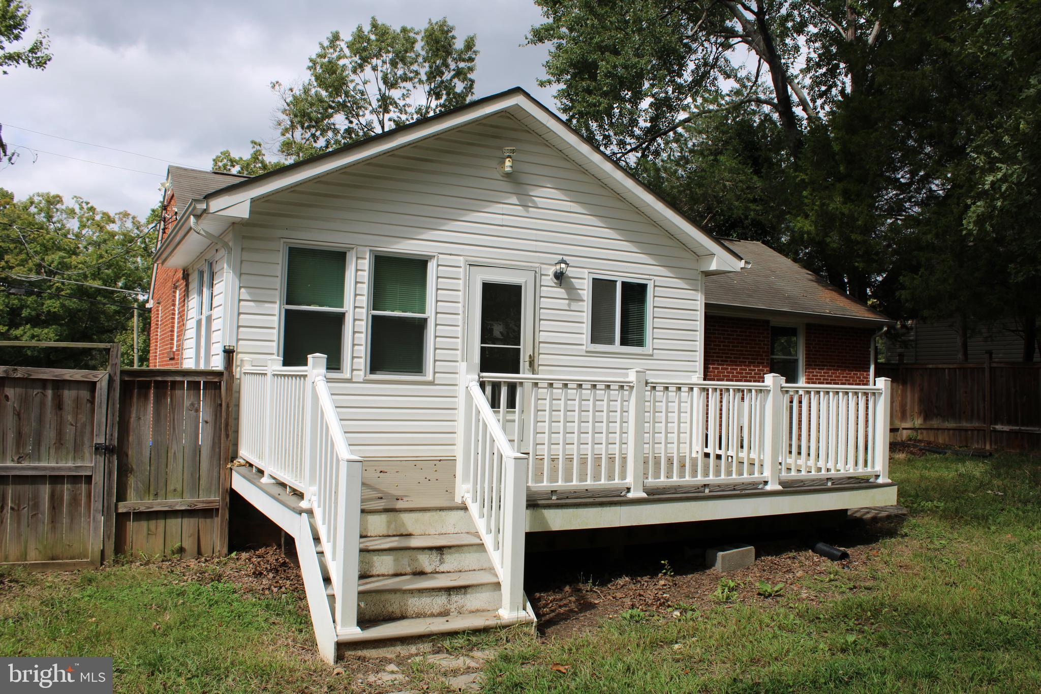 19115 Wayne Drive Triangle, VA 22172 - Photo 39 of 47 a view of a house with wooden deck and a yard