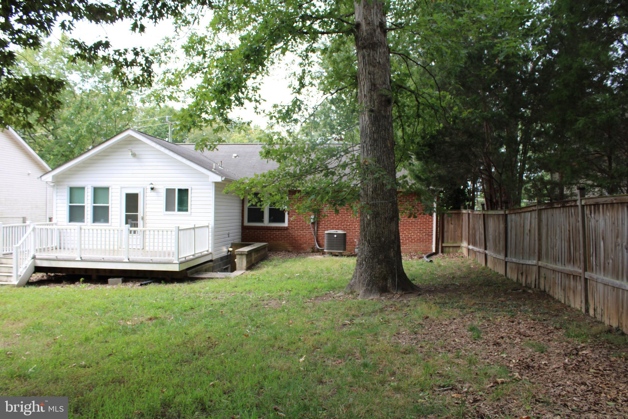19115 Wayne Drive Triangle, VA 22172 - Photo 42 of 47 a view of a house with a backyard and a tree