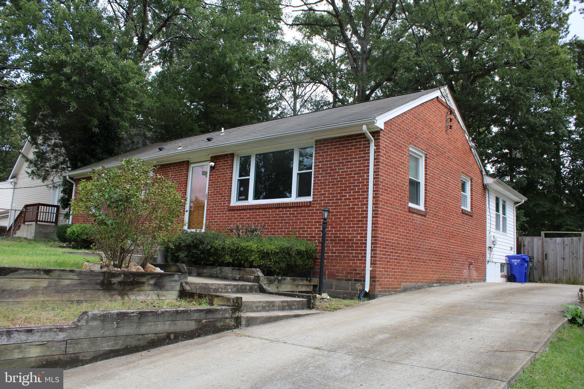 19115 Wayne Drive Triangle, VA 22172 - Photo 5 of 47 a backyard of a house with outdoor seating and trees