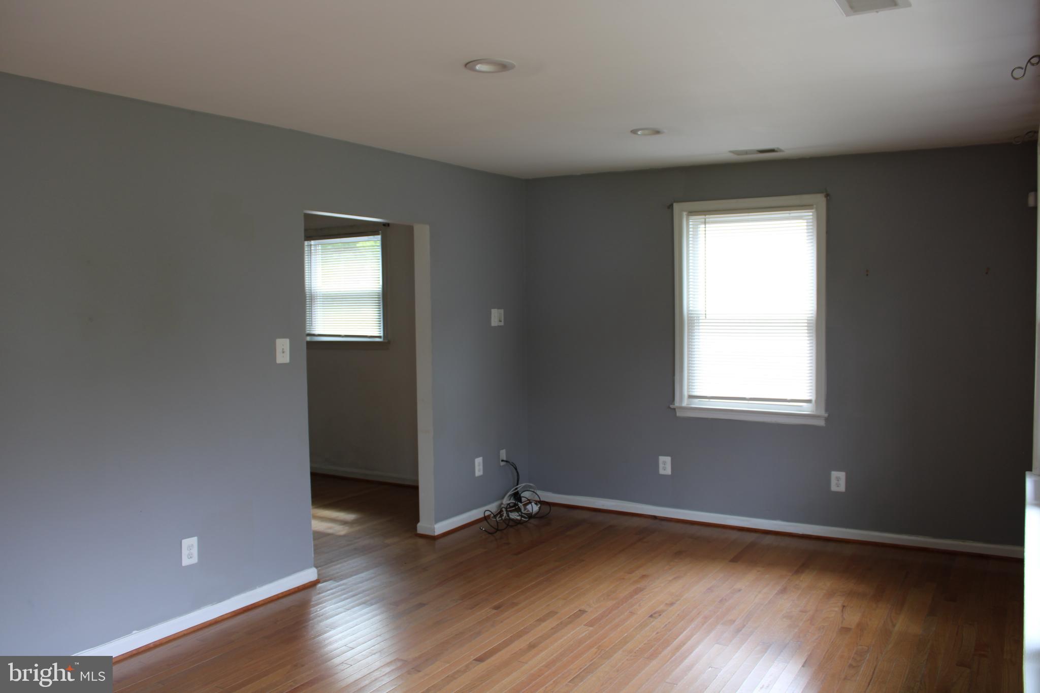 19115 Wayne Drive Triangle, VA 22172 - Photo 7 of 47 an empty room with wooden floor and windows