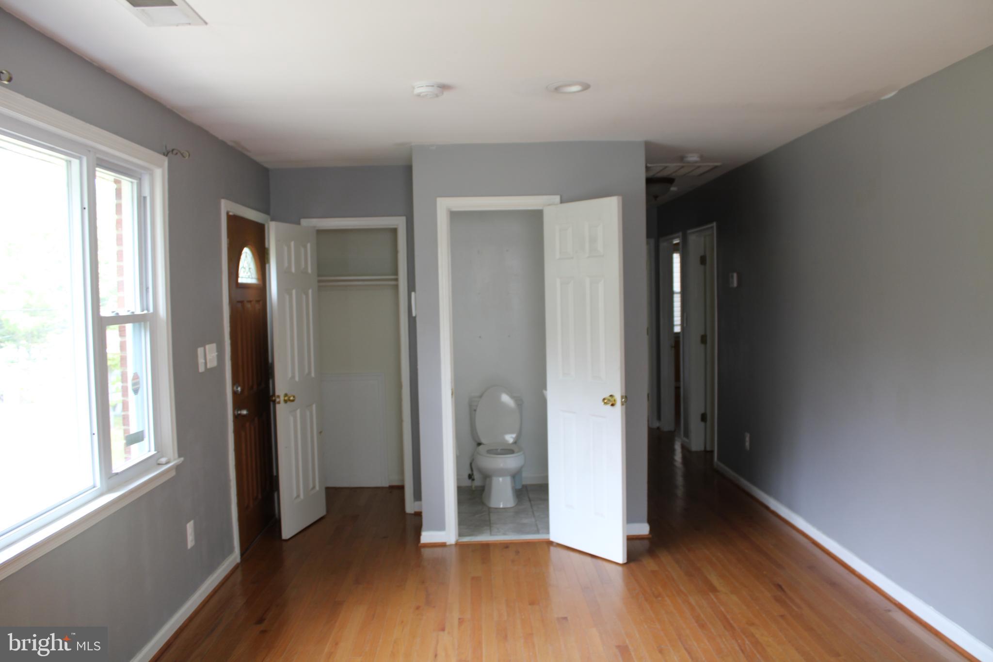 19115 Wayne Drive Triangle, VA 22172 - Photo 10 of 47 an empty room with wooden floor and windows