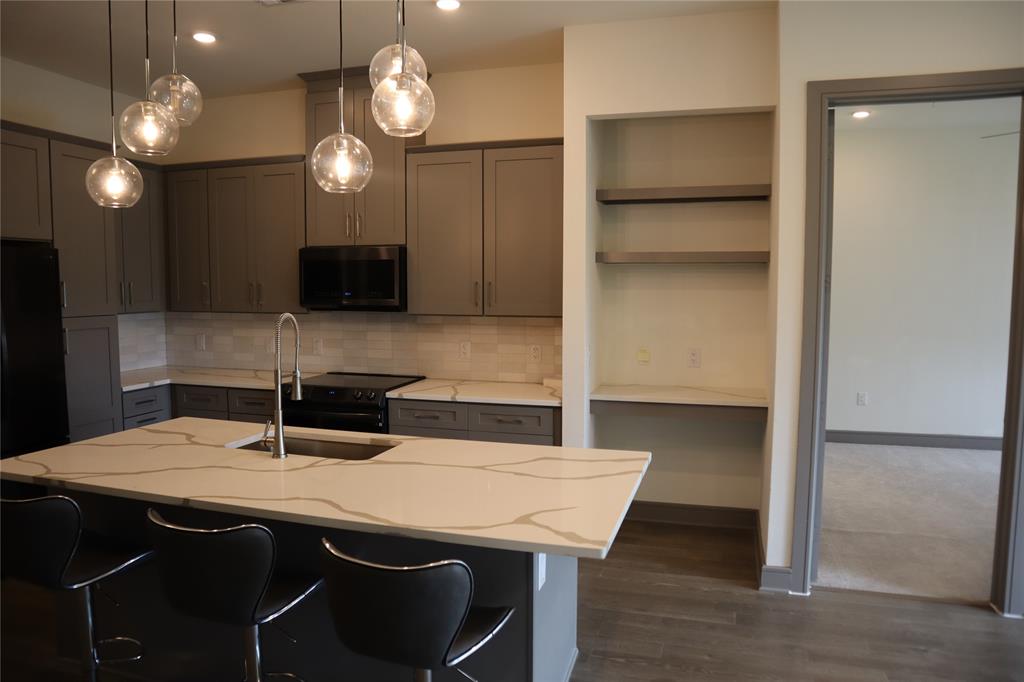2700 Old Denton Road, Unit 3314 Carrollton, TX 75007 - Photo 10 of 14 a kitchen with a table chairs and chandelier