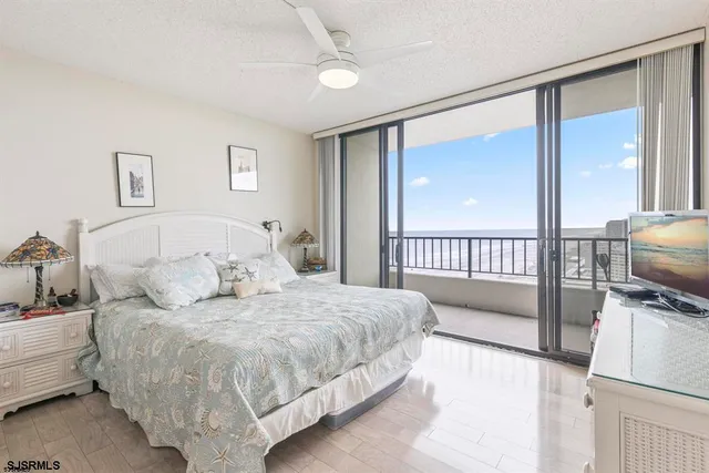 a bedroom with a bed and a view of balcony