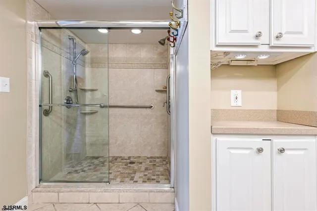 a bathroom with a shower and a sink