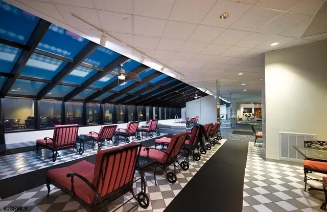 a sitting room with lots of wooden furniture and a chandelier