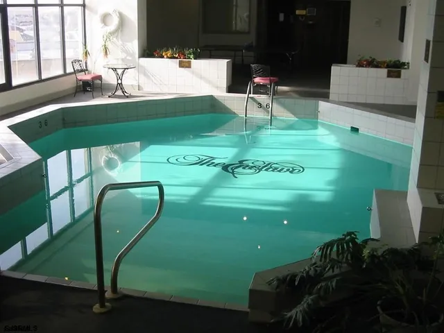 a green field with some trees in front of it